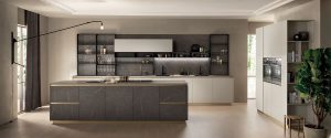 Cocina sofisticada de alma contemporánea. El color latón (de los perfiles del tirador, en las golas verticales y horizontales y en los zócalos) dibuja un motivo refinado en esta composición que da lugar a una síntesis perfecta de clase y diseño.